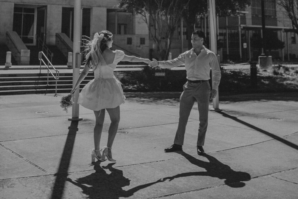 Couple dancing outside of a courthouse.