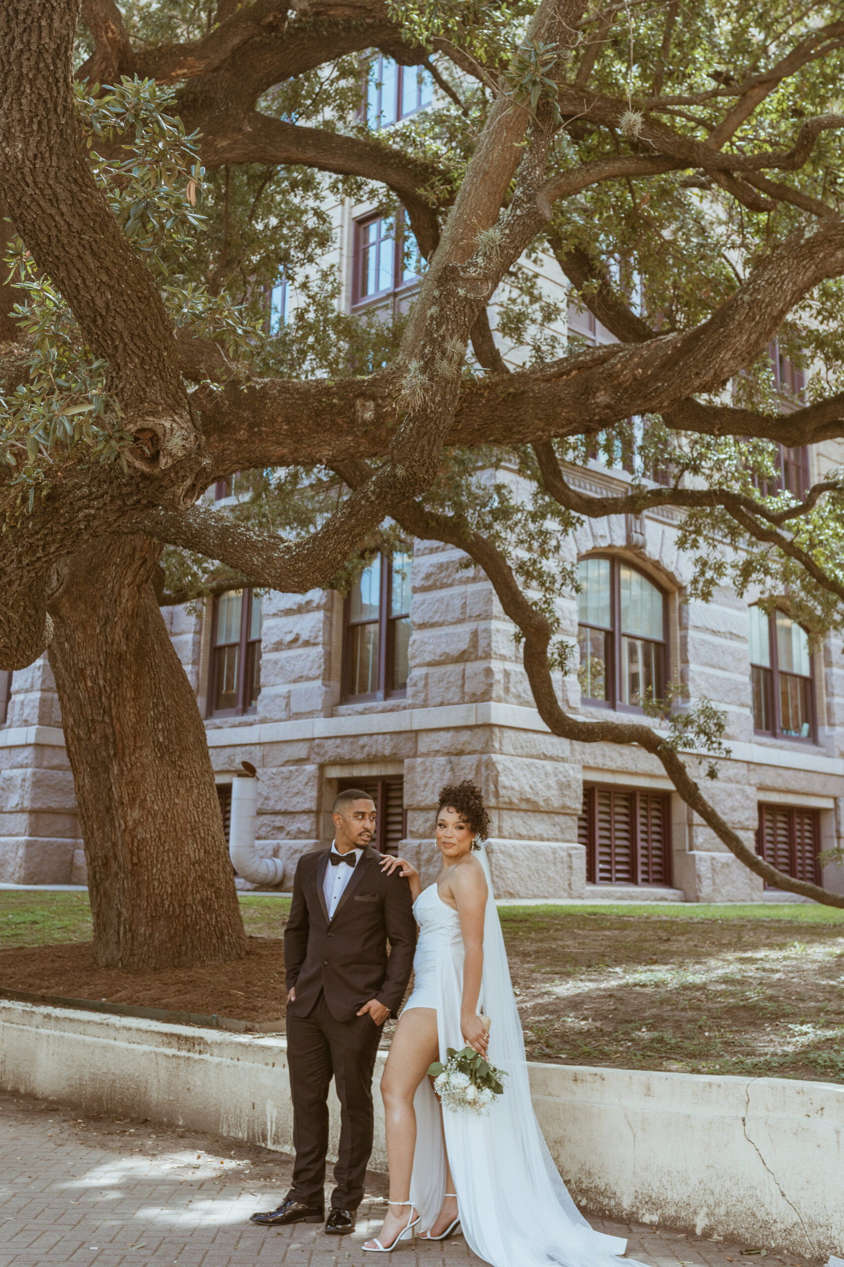Couple standing outside of a courthouse during their Houston Elopement