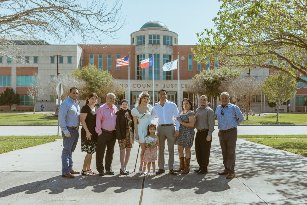 A big family in front of a courthouse building.