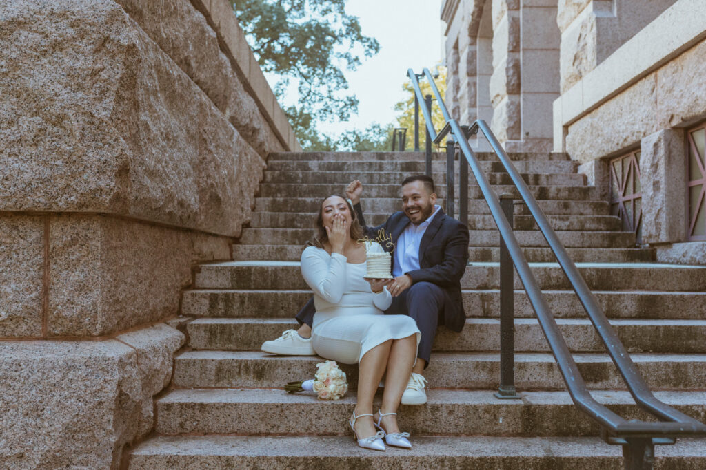 Couple sitting on the steps of a courthouse, celebrating their Downtown Houston Elopement.