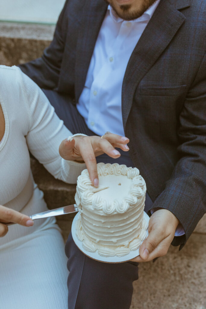 Couple cutting a cake during their Downtown Houston Elopement.