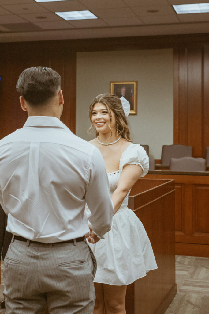 Couple about to get married, inside a courtroom.