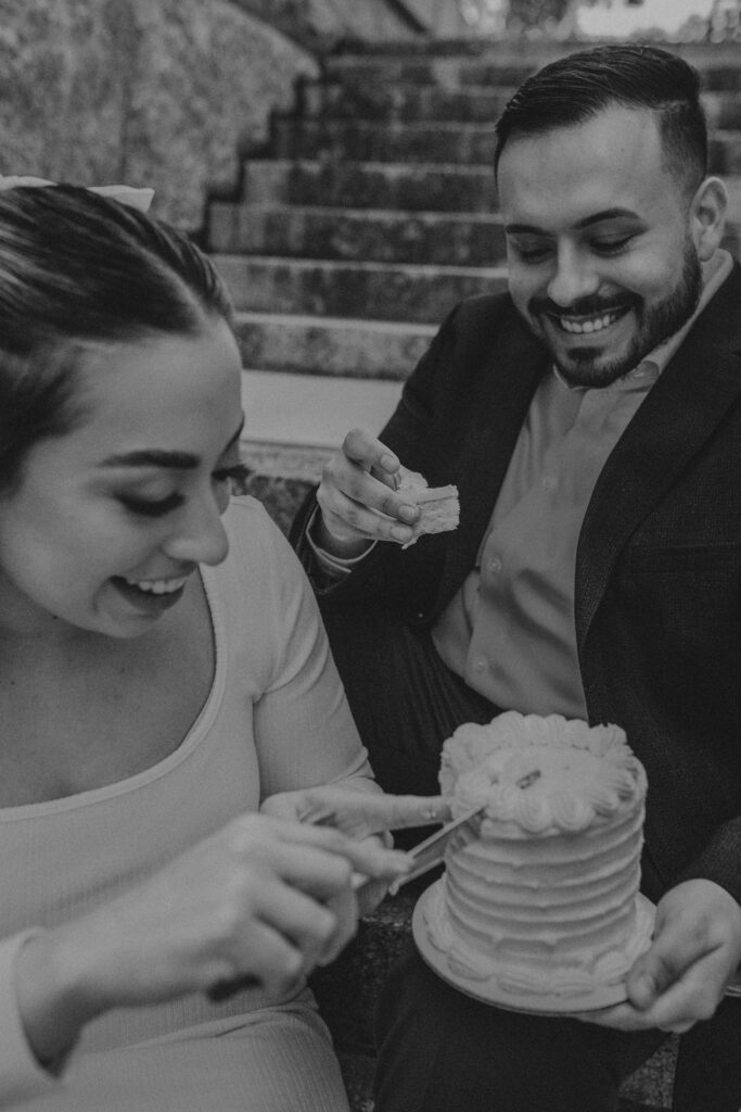 A couple cutting and eat a cake during their elopement. 