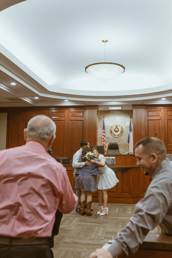 Family members hugging and celebrating a Houston elopement.