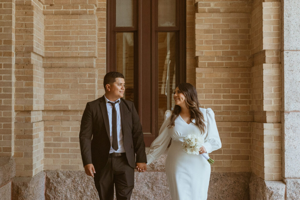Couple walking around a courthouse during their downtown Houston elopement.