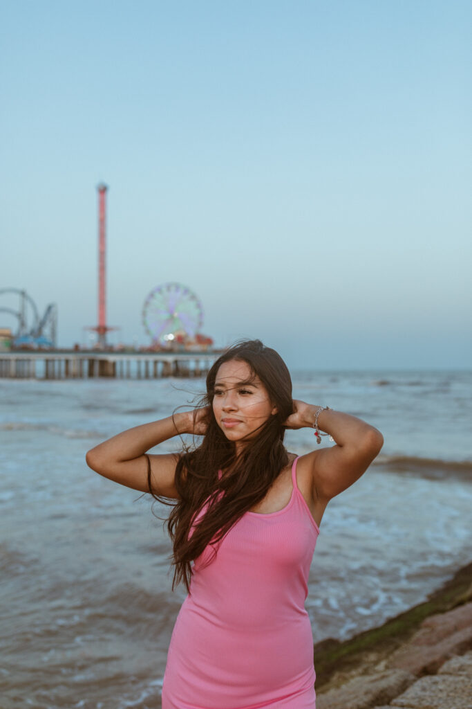 Girl in a pink dress, at the beach, for a summer photoshoot