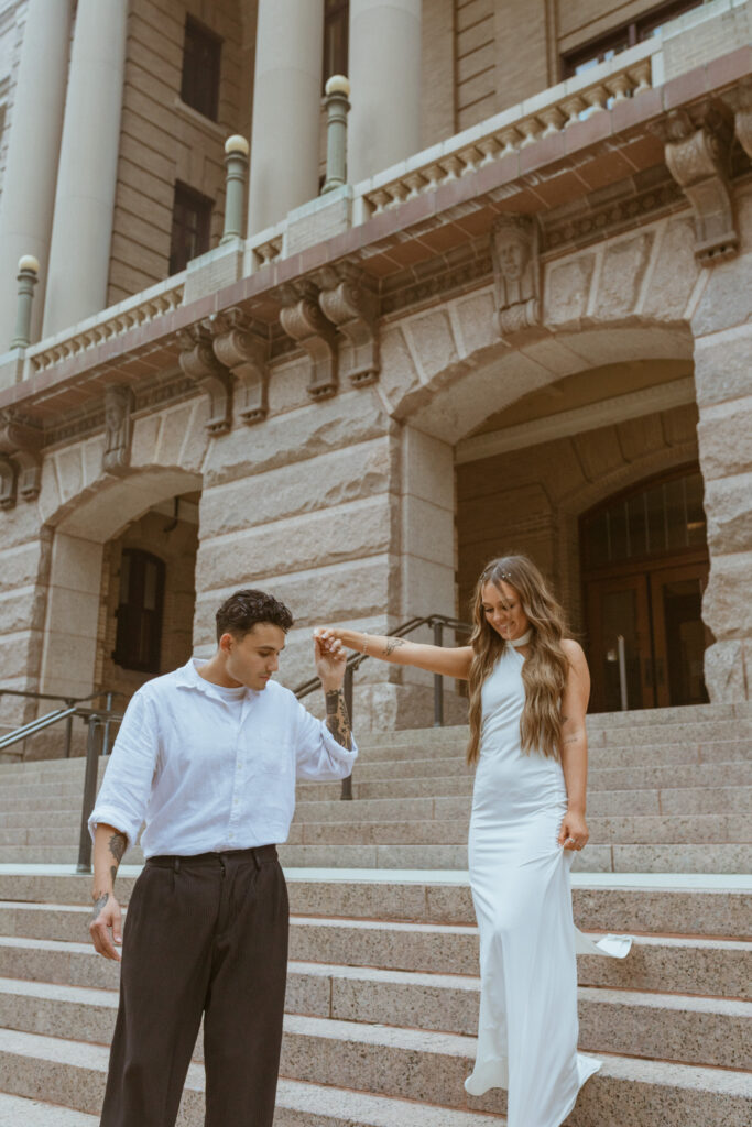 Couple walking down the steps of a courthouse.
