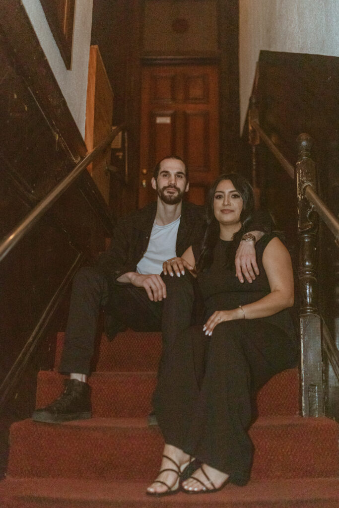 Couple sitting on the stair case of Captain Foxheart's Bad News Bar.