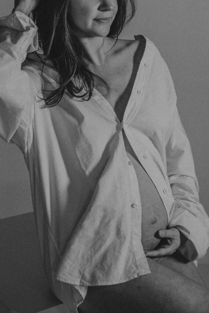 Studio photoshoot of a women with a white long sleeve shirt. 