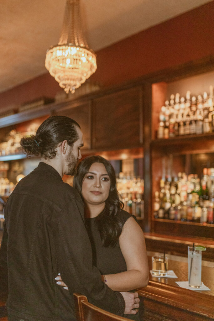 Couple at a bar for their engagement photos
