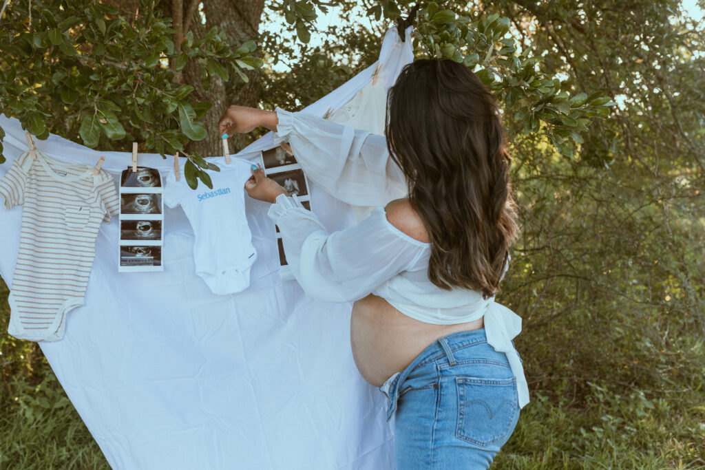 Women hanging baby clothes.