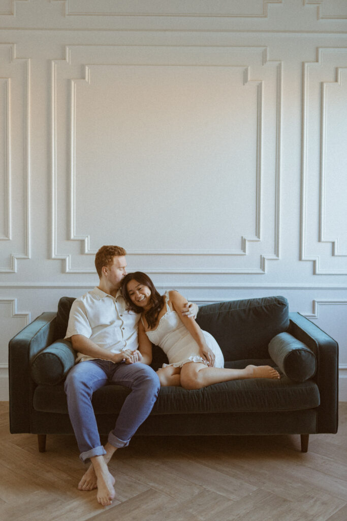 Couple sitting on the couch for their engagement photos