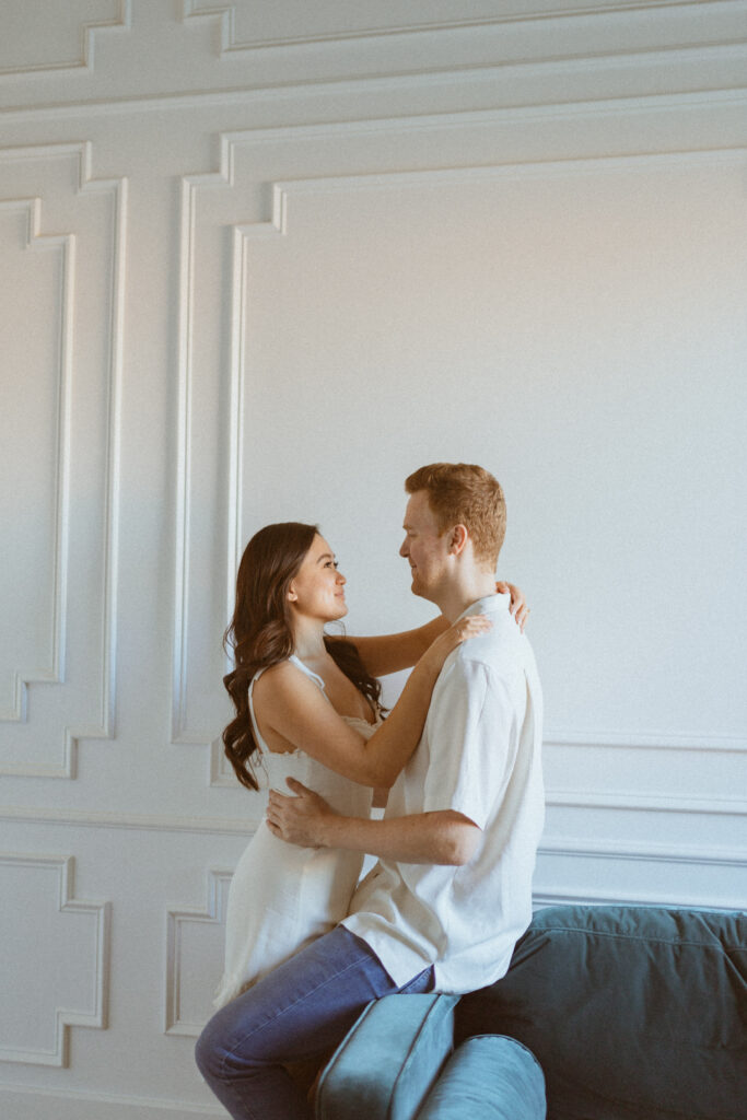 Couple facing each other and hugging during their engagement photos.