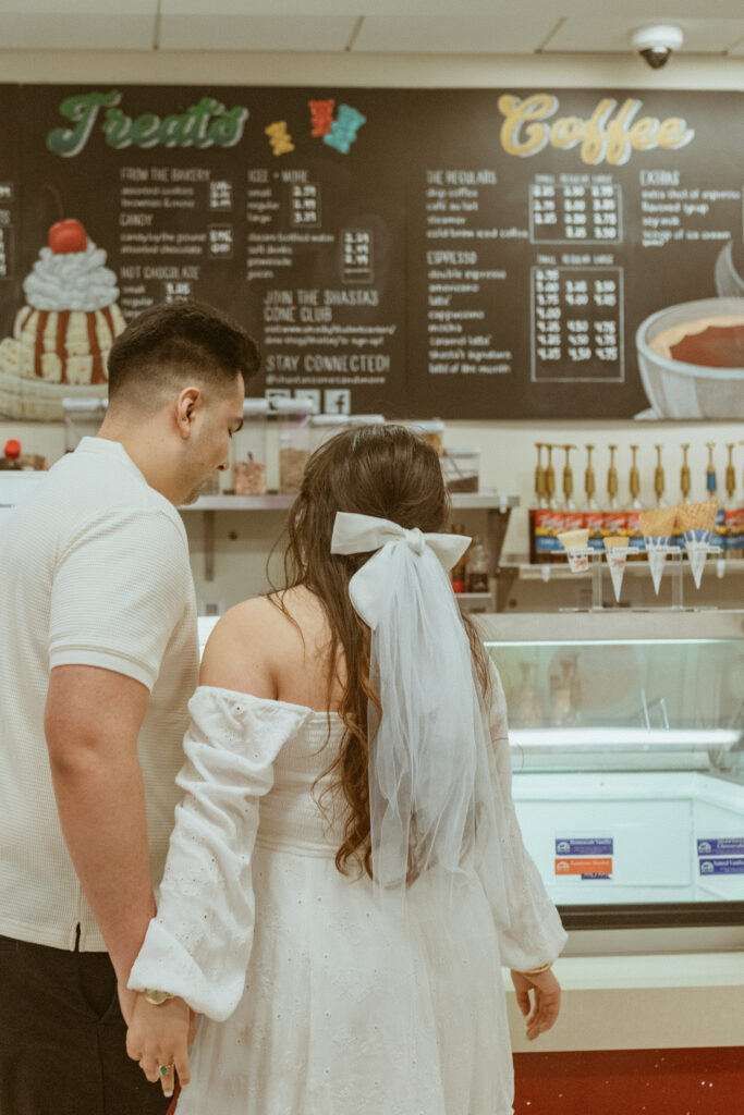 Couple taking engagement photos at the university of Houston