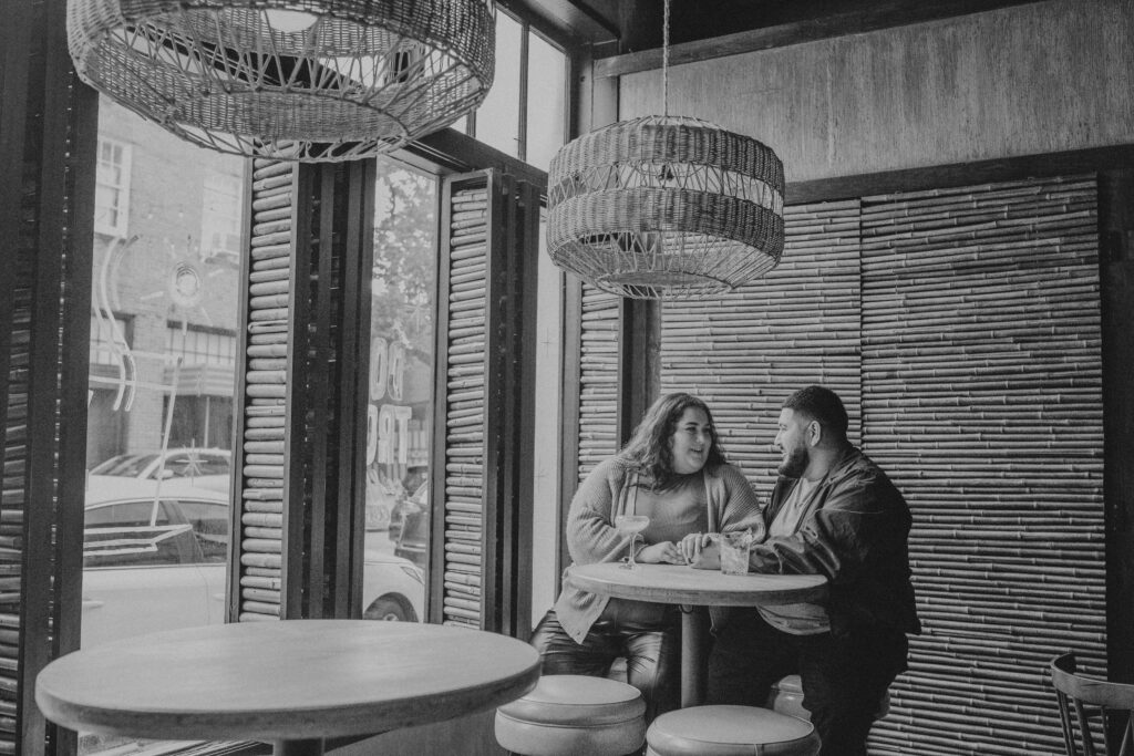 Couple sitting at a table at a restaurant with drinks on the table