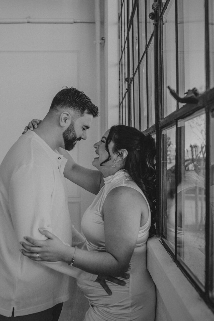 Couple laughing during their maternity photoshoot