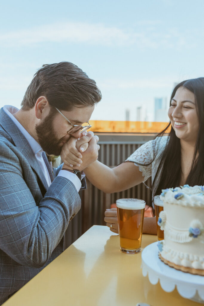 Man kissing his wife's hand after getting married in Houston, Tx