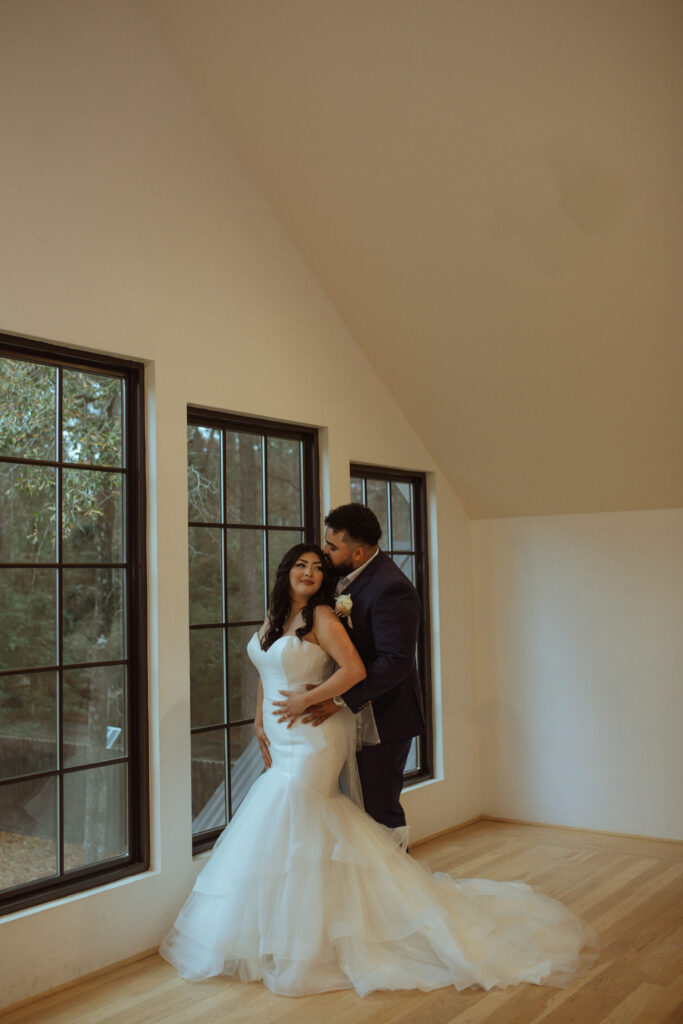 Couple posing for their wedding photos inside the Oak Atelier.