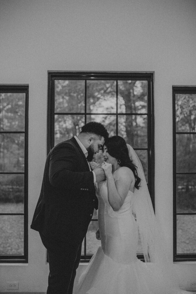 Couple praying during their wedding photos at the Oak Atelier.