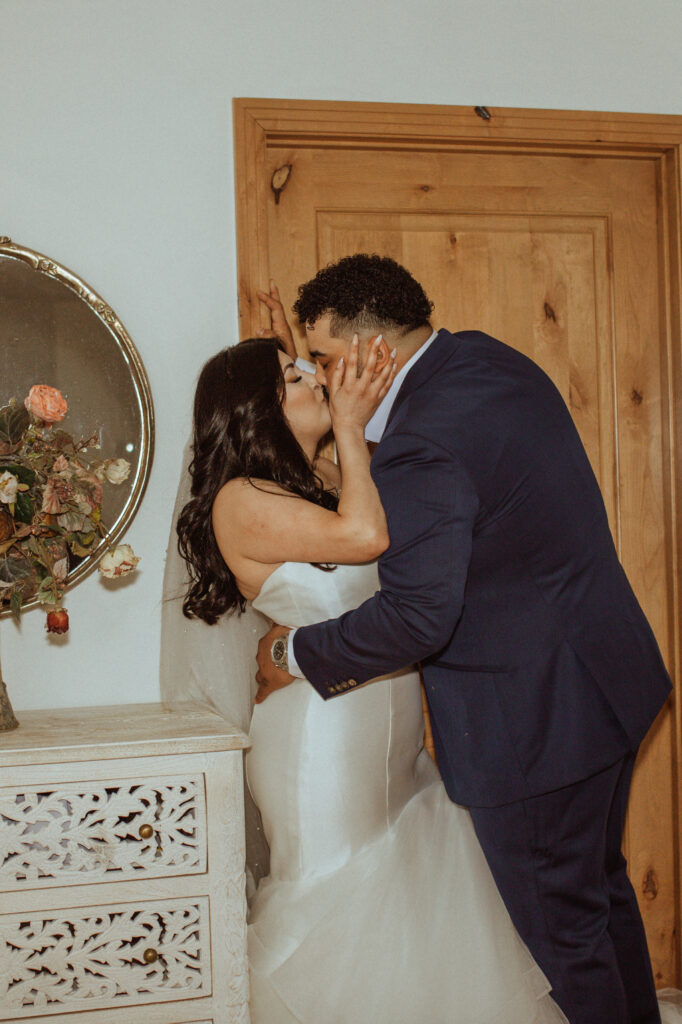 Couple kissing during their wedding photos.