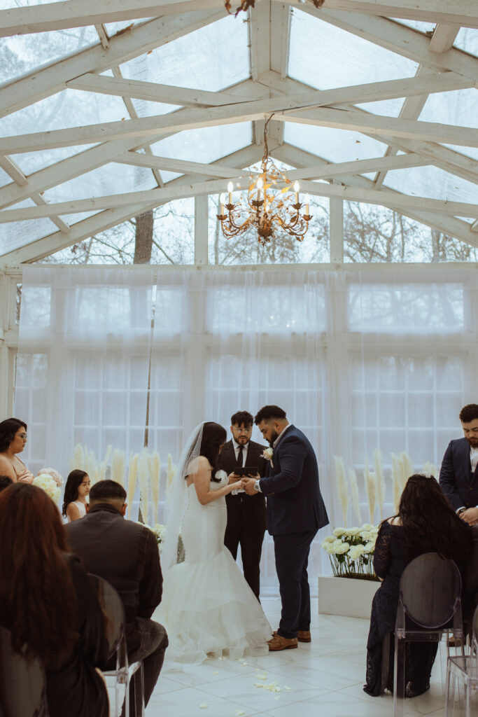 Couple praying during their wedding ceremony at the Oak Atelier.