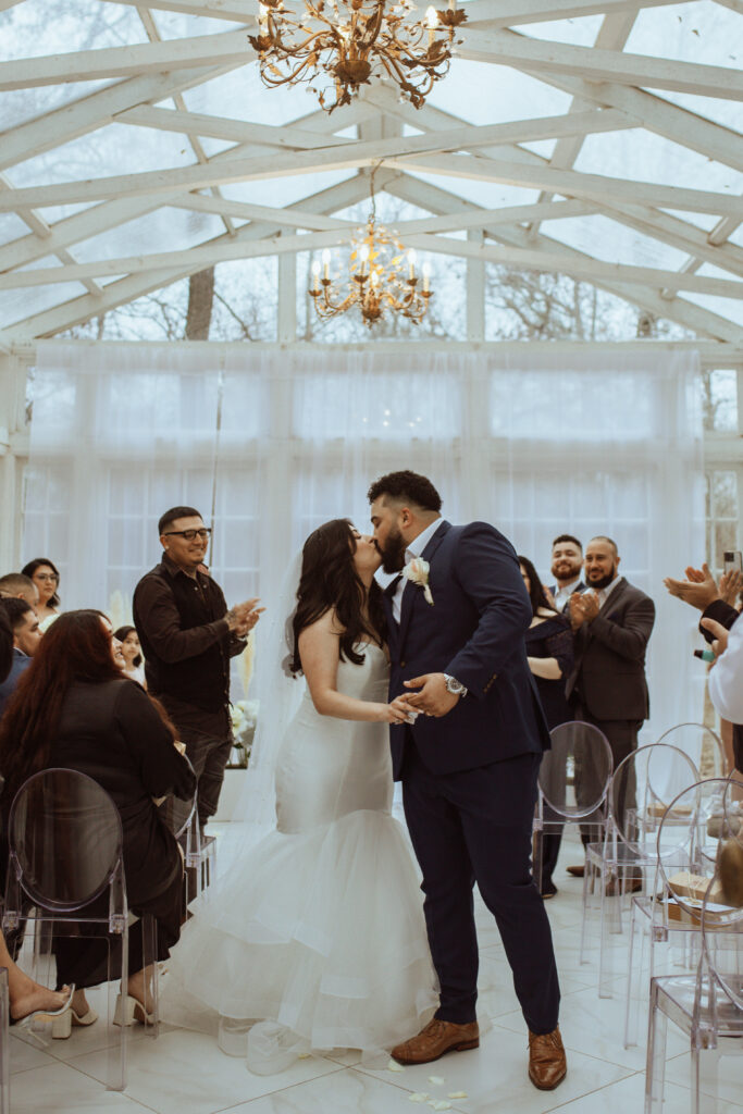 Couple kissing after the wedding ceremony at the Oak Atelier.