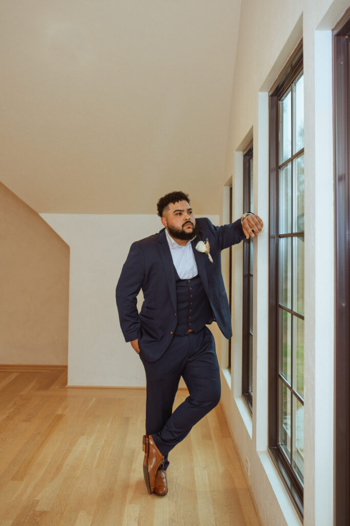 Groom posing for his wedding photos at Oak Atelier.