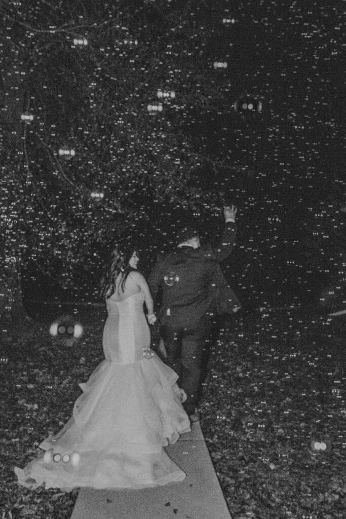 Couple leaving their wedding with a bubble exit after their wedding at the Oak Atelier.
