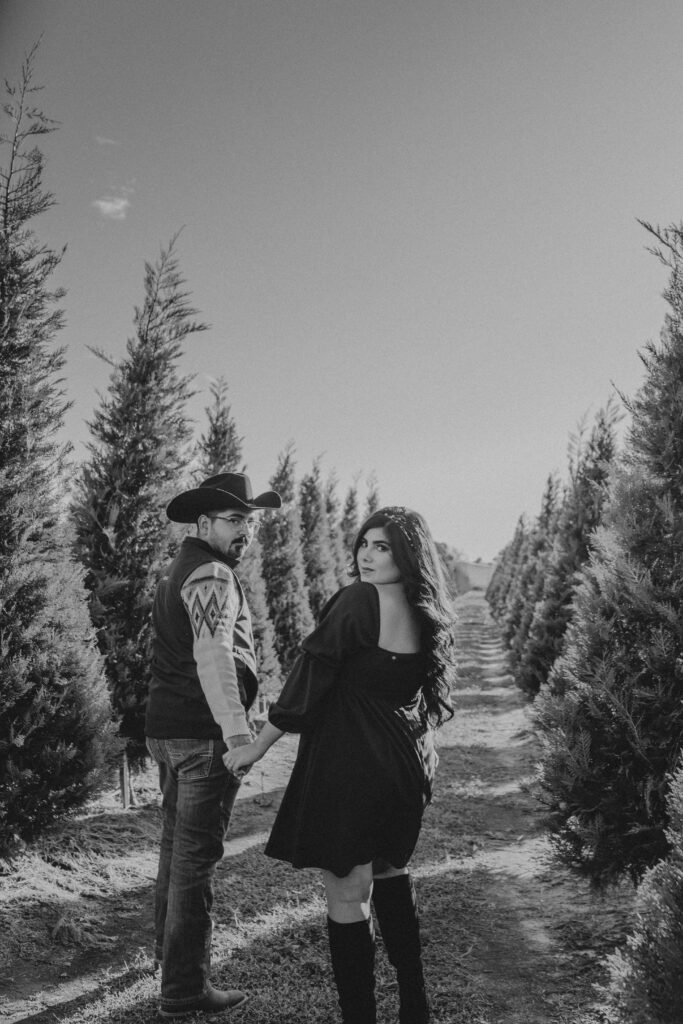 Couple walking holding hands during a winter photoshoot