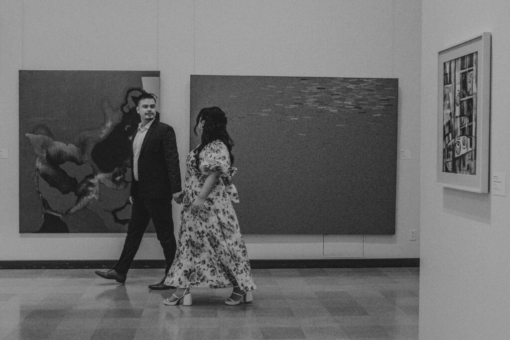 Couple walking inside an art gallery.