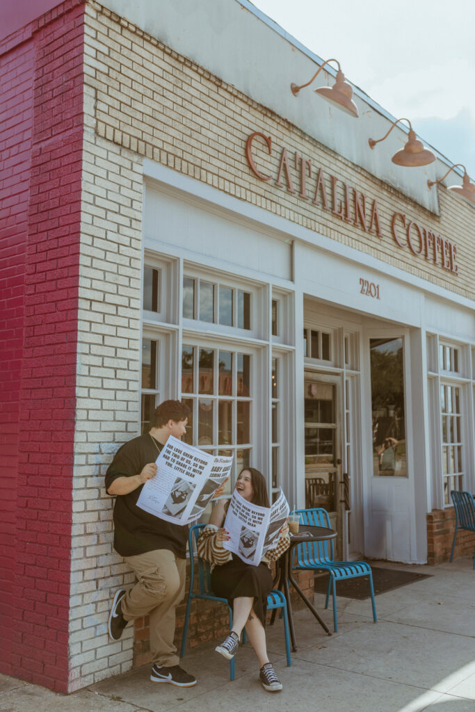 Couple holding news paper of their Pregnancy Announcement at Catalina Coffee