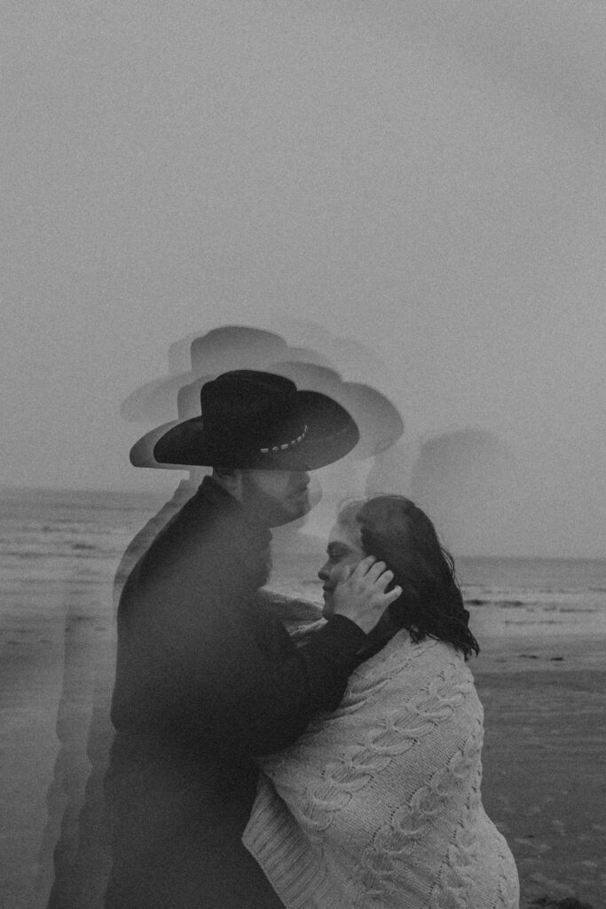 Couple hugging un the beach doing a winter photoshoot