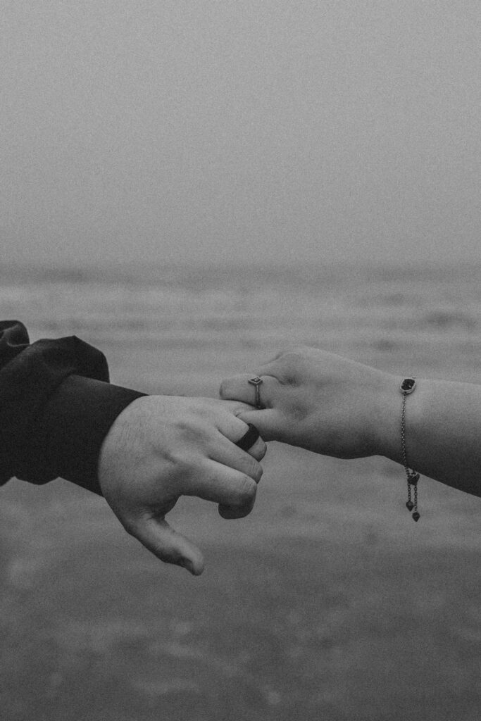 couples holding hands on the beach during a Winter Photoshoot Ideas