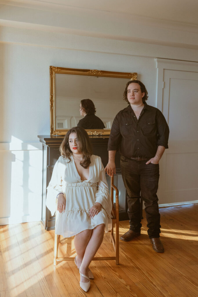 Couple taking fall photos inside a studio.